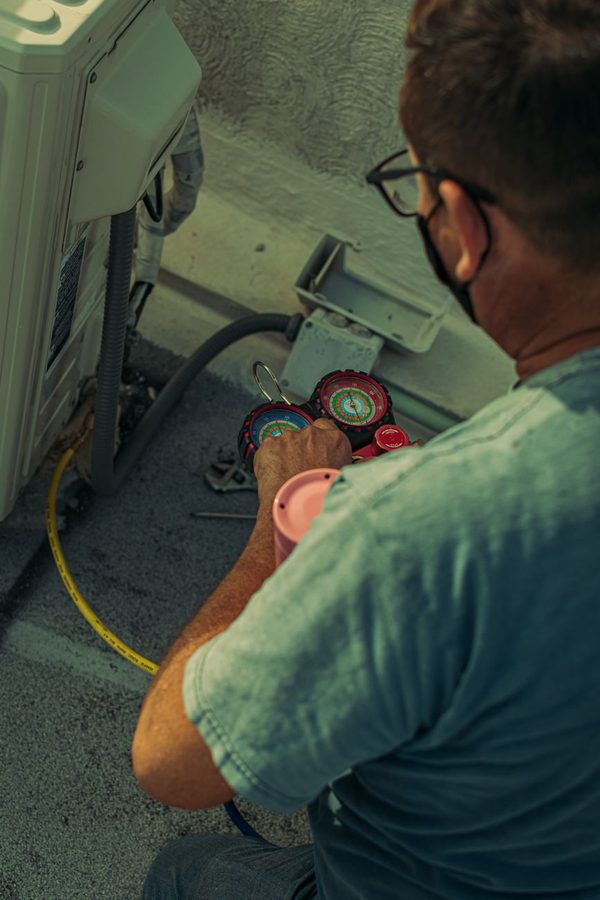 HVAC technician checking an air conditioning unit