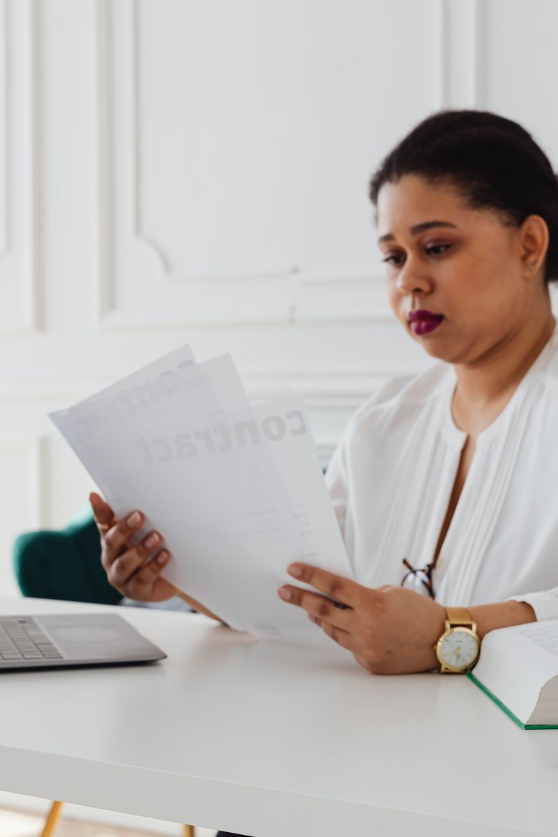 Attorney reviewing legal documents at her office desk
